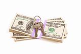 House Keys on Stack of Money Isolated on a White Background - Cash for Keys Program.