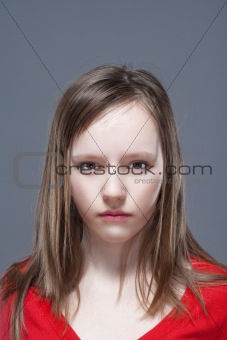 studio shot of an eleven years old girl posing as a fashion model