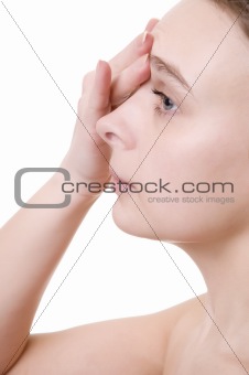 Young beautiful girl applying cream on her forehead