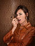 Woman in dark leather coat with cigar