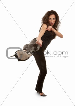 Tough woman in high heels kicking at camera