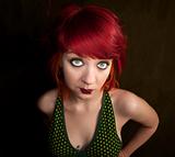Pretty punky girl with brightly dyed red hair