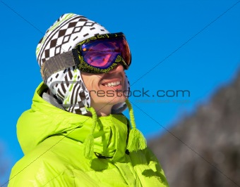 Young man smiling in ski mask