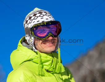 Young man smiling in ski mask