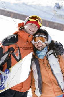 Lucky couple  snowboarders  in a mountain valley