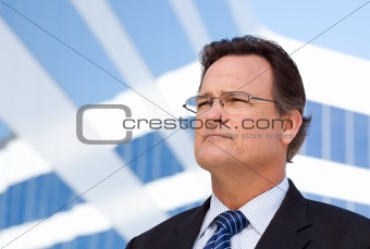 Handsome, Confident Businessman Outside of Corporate Building Looking Into The Distance.