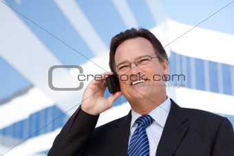 Confident, Handsome Businessman Smiles as He Talks on His Cell Phone.