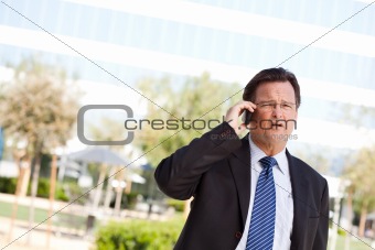 Concerned, Stressed Businessman Talks on His Cell Phone.