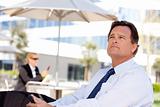 Handsome Businessman in Necktie Looks Off Into the Distance During a Break Outdoors.