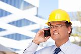 Handsome Contractor in Hardhat and Necktie Smiles as He Talks on His Cell Phone.