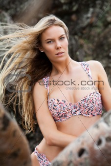 Young Woman Wearing Bikini Posing on Rock Formation
