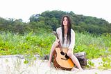 Attractive Young Woman Outdoors With Guitar
