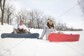 Happy couple of snowboarders