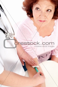 Senior woman getting blood analysis
