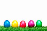 Several Colorful Easter eggs on a green meadow