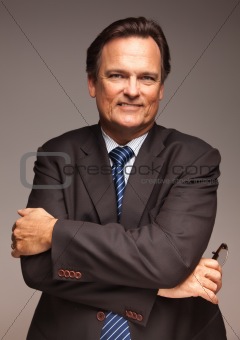 Handsome Businessman Smiling in Suit and Tie Isolated on a Grey Background.