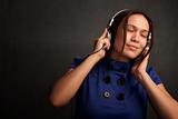 Pretty young woman in a blue dress with Headphones
