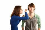 Pretty young woman interupts man with headphones