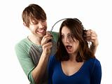 Pretty young woman interupts man with headphones