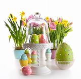 Easter eggs on cake stand with spring flowers 