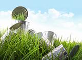 Empty food cans in grass with blue sky