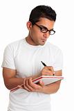 Student or man wearing glasses writing