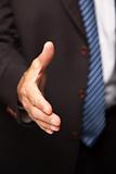 Businessman Reaching His Hand Out for a Handshake.