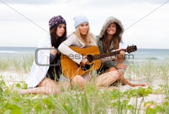 Young Women at the Beach With a Guitar