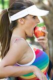 Young Woman Eating Apple Outdoors