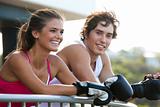 Young Couple in Boxing Gloves Leaning on Railing