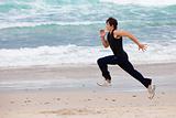 Young Man Running on Beach