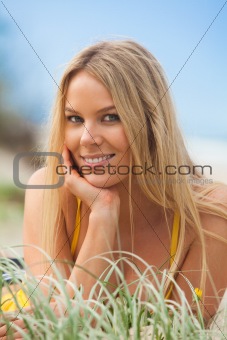 Smiling Young Woman Lying in Grass