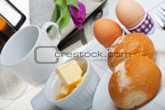 eggs, bun, butter and coffee on white background