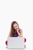 young girl sitting with laptop computer - isolated on white