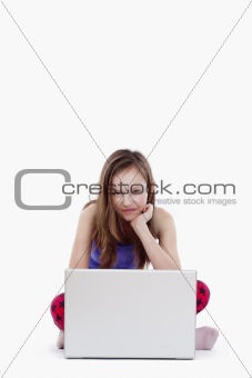 young girl with laptop computer smiling - isolated on white