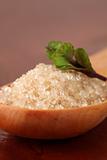 Cane sugar in a wooden spoon