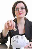 business woman putting money coins in piggy bank