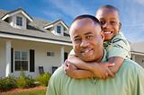 Happy African American Father and Son Outside of their Home.