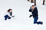 Young couple playing outdoors in the snow.