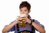 Young handsome man drinking out of Oktoberfest beer stein (Mass)