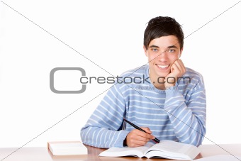 Young happy handsome male student sitting on desk learning for e