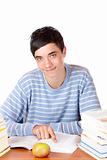 Young happy handsome male student sitting on desk learning with 