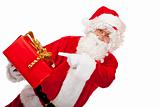 Old Santa Claus holding Christmas gift and pointing with finger 