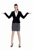 Beautiful business woman streching both the hands and pointing empty space