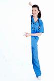 Smiling young nurse pointing blank board