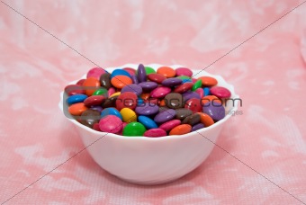 bowl of smarties on pink background
