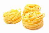 Three uncooked pasta nests