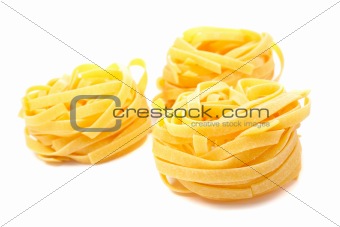 Three uncooked pasta nests