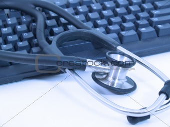 Stethoscope next to computer keyboard