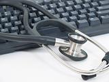 Stethoscope next to computer keyboard